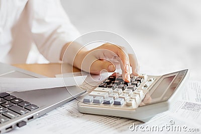 girl doing accounting calculations using a calculator Stock Photo