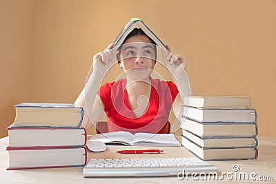 Girl doing her homework. School books on desk, education concept. Young Girl doing lessons at home Stock Photo
