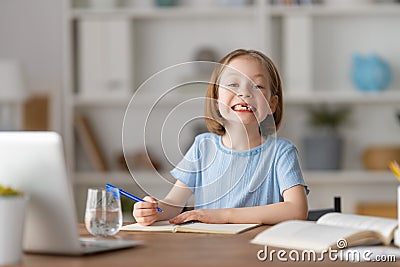 Girl doing homework or online education Stock Photo