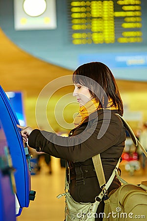 Girl doing self-checkin in the airport Stock Photo