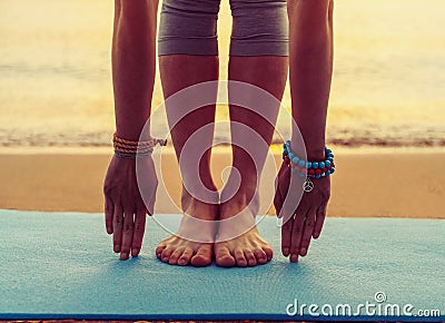 Girl doing yoga exercise on beach Stock Photo