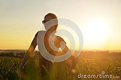 Girl doing yoga at sunset. Stock Photo