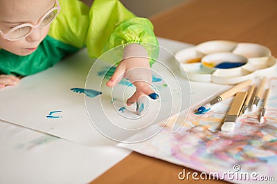 Girl with Down syndrome draws paints Stock Photo