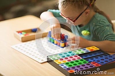 Girl with Down syndrome is very focused Stock Photo