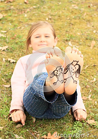 Girl with drawen hearts on soles Stock Photo