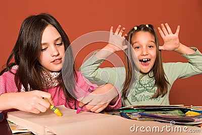 Girl drawing and cheeky girl Stock Photo