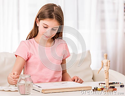 Girl drawing from figure with paint Stock Photo