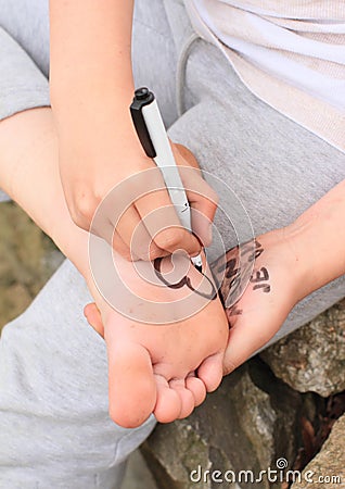 Girl drawing heart on her sole Stock Photo