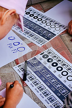 Girl is drawing on a paper Stock Photo