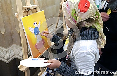 The girl draws an angel in the Cathedral of Christ the Savior Editorial Stock Photo