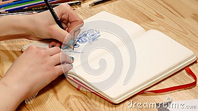 The girl draws pencil sketch on paper. Close up Stock Photo