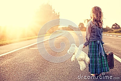 The girl in a dress with a suitcase Stock Photo