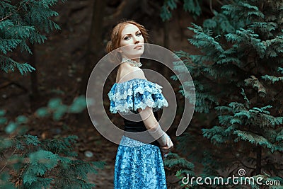 Girl dressed in an old-fashioned blue dress. Stock Photo