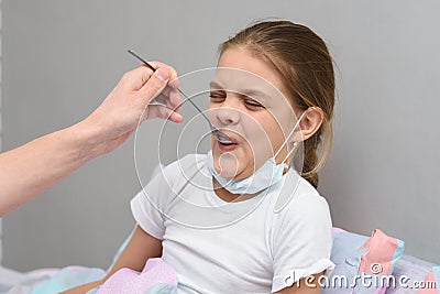 Girl drinking a very nasty medicine from a spoon Stock Photo