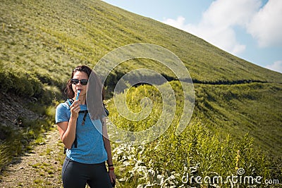 Girl drinking water from her hydration pack Stock Photo