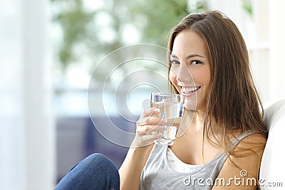 Girl drinking water at home Stock Photo