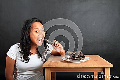 Girl eating beef biltong - African dried meet Stock Photo