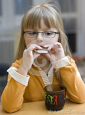 Girl eating cookie Stock Photo