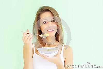 Girl eating cornflakes Stock Photo