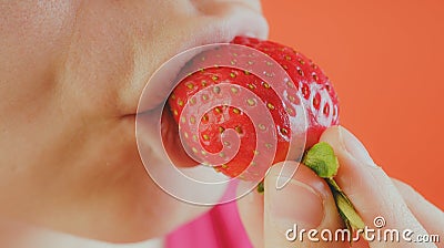 Girl eating fresh strawberries, close-up Stock Photo