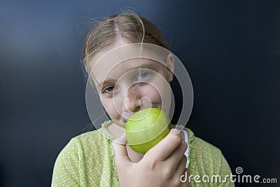 Girl eating a green apple Stock Photo