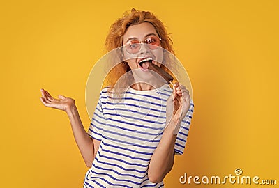 girl eating icelolly ice cream at summer. girl with icelolly ice cream isolated on yellow. girl with icelolly ice cream Stock Photo