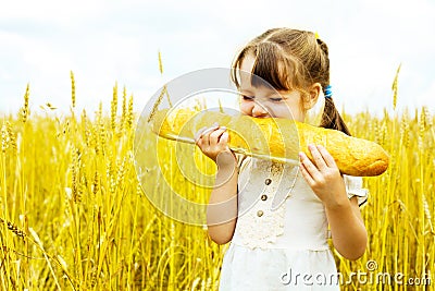 Girl eating a long loaf Stock Photo