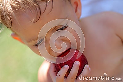 Girl eating peach Stock Photo