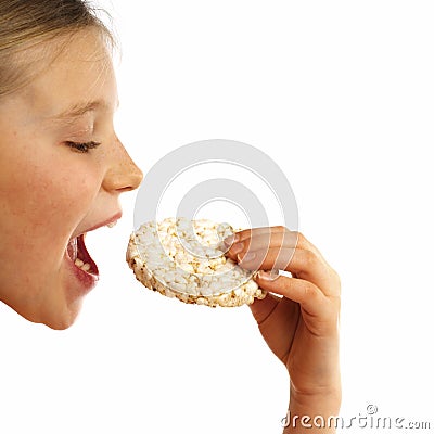 Girl eating a rice waffle Stock Photo