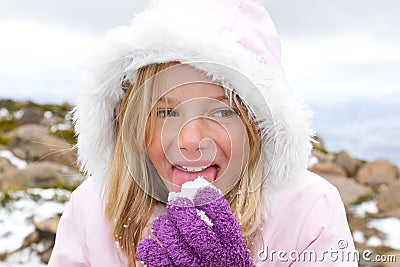 Girl eating snow Stock Photo