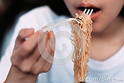 A girl eating spicy noodle cup Stock Photo