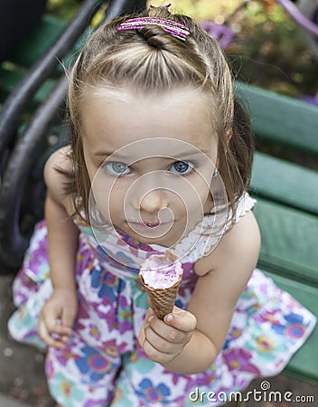 A girl eats an ice cream in park Stock Photo