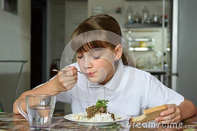 Girl eats the second dish for lunch Stock Photo