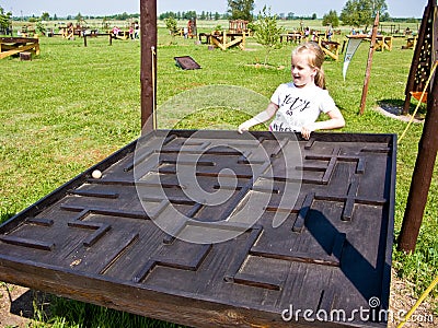 Girl and educational toy outdoors Stock Photo