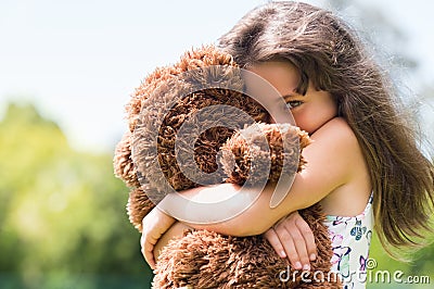 Girl embracing teddy bear Stock Photo