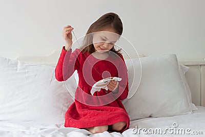 The girl embroiders with a cross Stock Photo