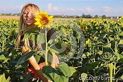 Girl in a field of blooming sunflowers in nature. Happy, perky and cheerful Stock Photo