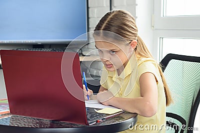 The girl is engaged in additional tutoring online Stock Photo