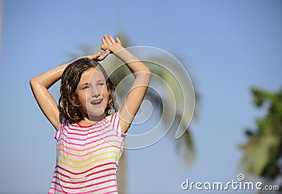 Girl enjoying the light summer rain. Stock Photo