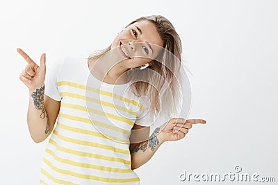 Girl enjoying moment with great music in earbuds. Positive good-looking and joyful female, dancing and tilting head Stock Photo