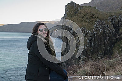 The girl enjoys the view of the cliffs of Northern Ireland. Stock Photo