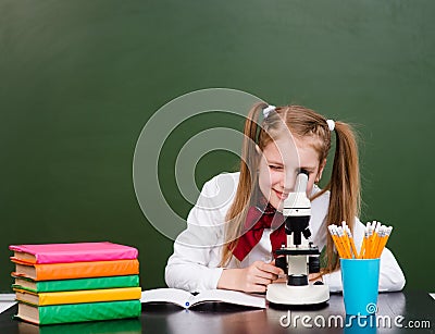 Girl examining preparation under the microscope Stock Photo