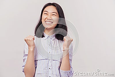 Girl excited for success with arms raised Stock Photo