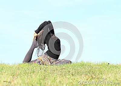 Girl exercising yoga - pigeon pose Stock Photo