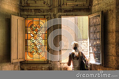 A girl facing near a stained glass window Stock Photo