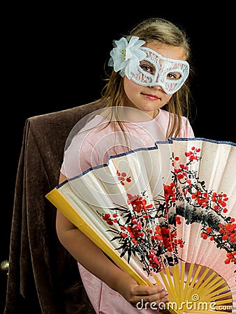 Girl with fan and mask in dress Stock Photo