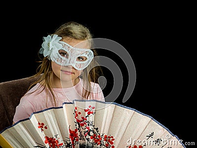 Girl with fan and mask in dress Stock Photo