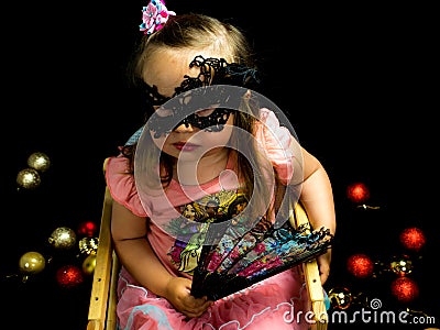 Girl with fan and mask in dress Stock Photo