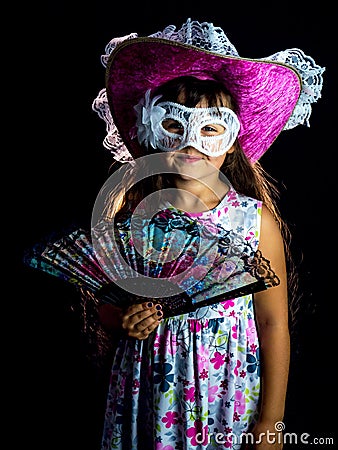 Girl with fan and mask in dress Stock Photo