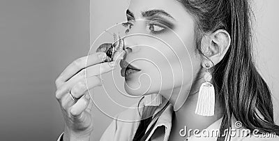 Girl fashionable makeup face and cute snail. Cosmetology beauty procedure. Skin care. Massage with snail. Skincare Stock Photo